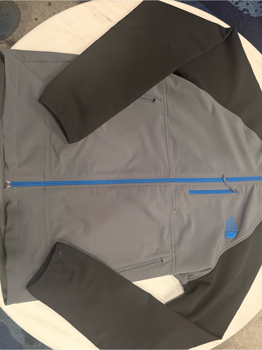 The North Face Men’s Gray Softshell Jacket with Black Sleeves and Blue Trim